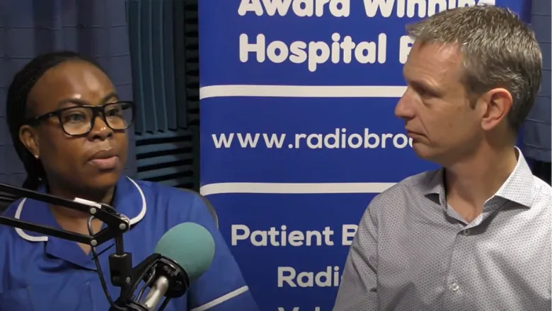 A person in a blue nurses' uniform and a person in a shirt speak with a microphone being interviewed on a podcast.