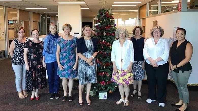 Jackie Sturt and research colleagues by a Christmas tree