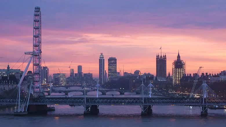 photo of London looking up the Thames river at sunset - red sky