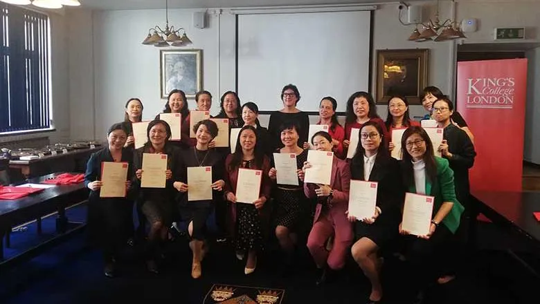 Group of people holding certificates