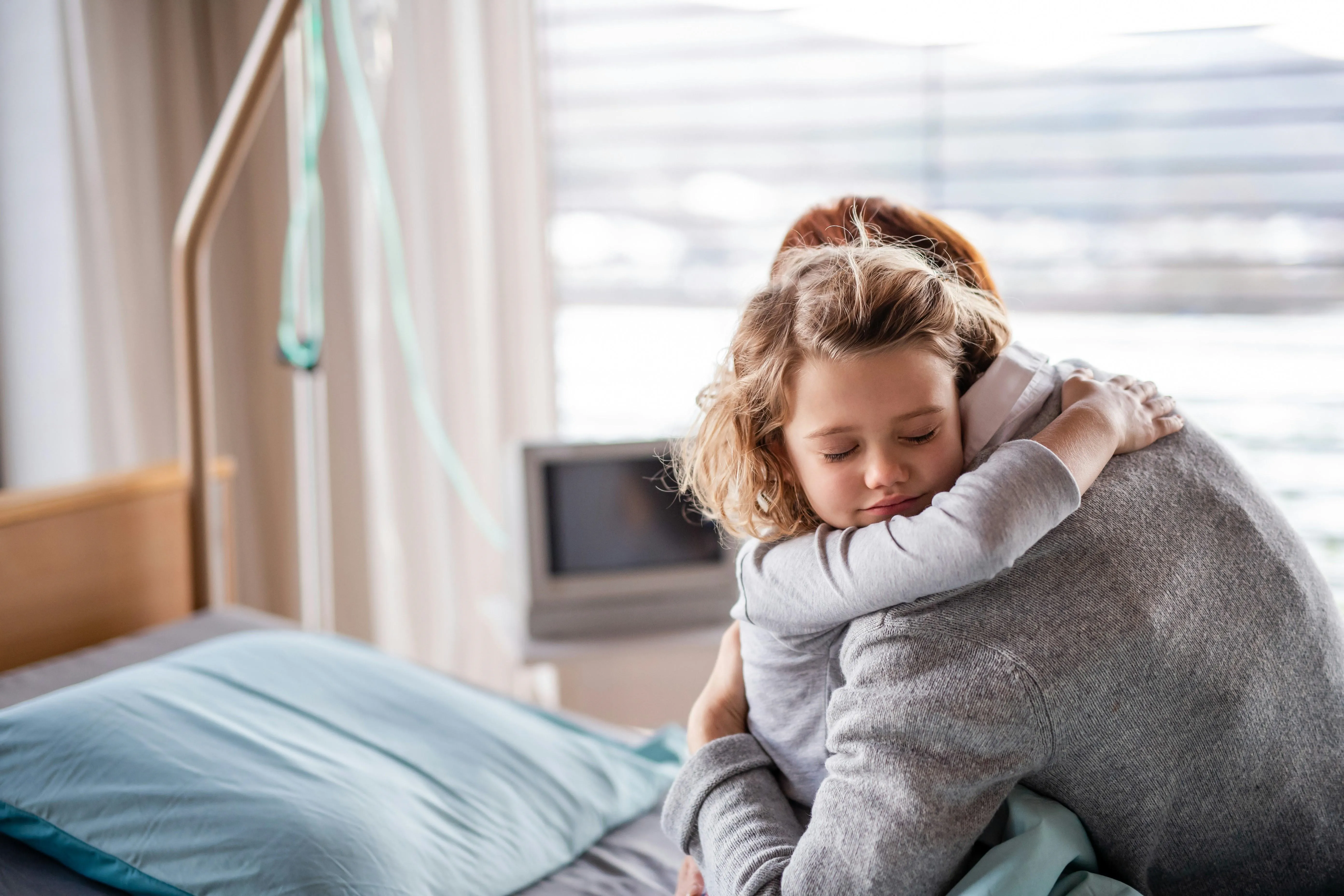 Parent and child hug in hospital