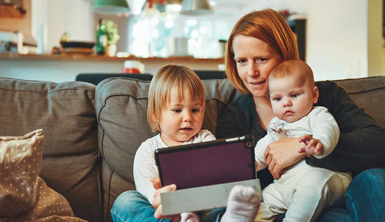 Parent and children using a tablet