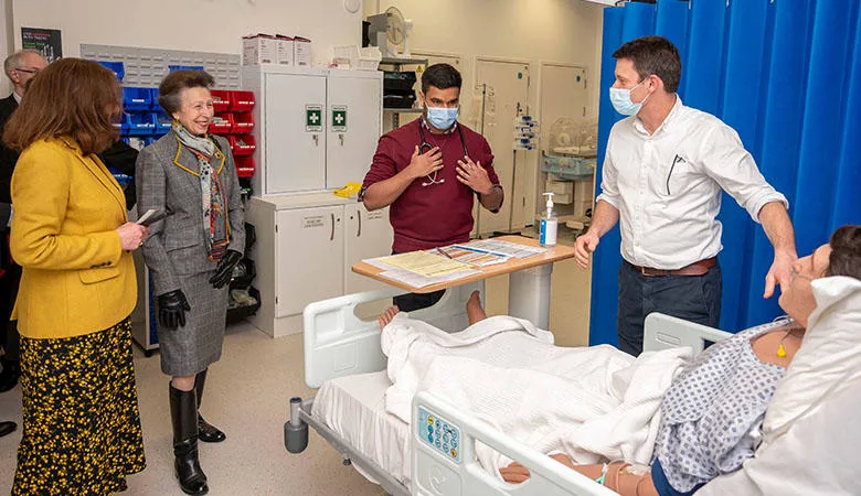 Princess Anne with a student and a clinical teacher next to a clinical simulation mannikin