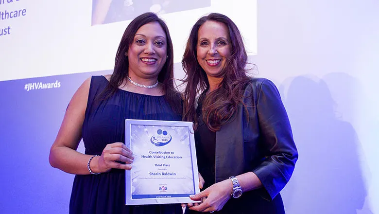 Two people holding a certificate