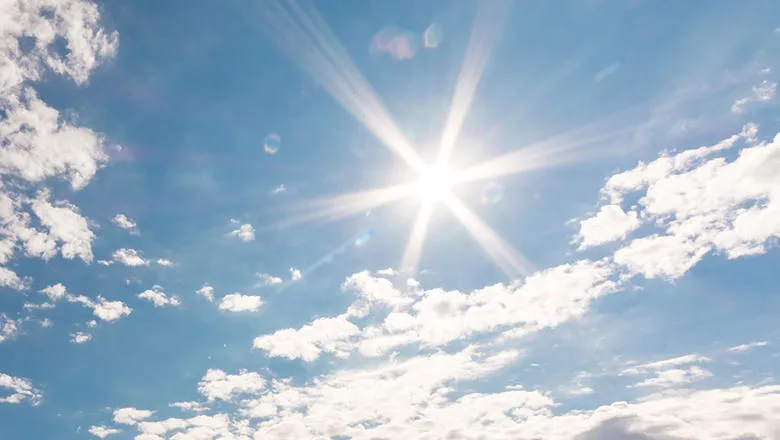 Sunshine and clouds in a blue sky