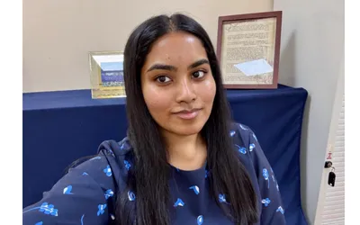 Verny, an NIHR INSIGHT scholarship student with dark hair, smiling at the camera.
