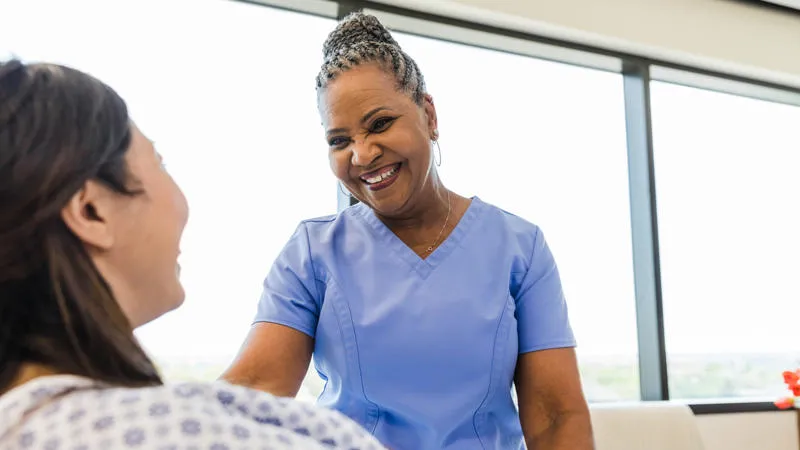 Nurse smiling at a patient
