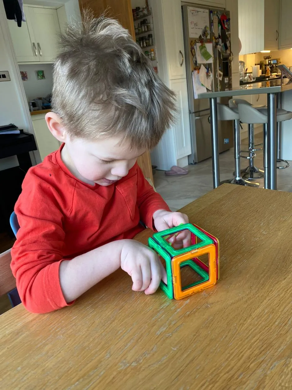 Child with hemiplegia doing upper limb rehabilitation at home