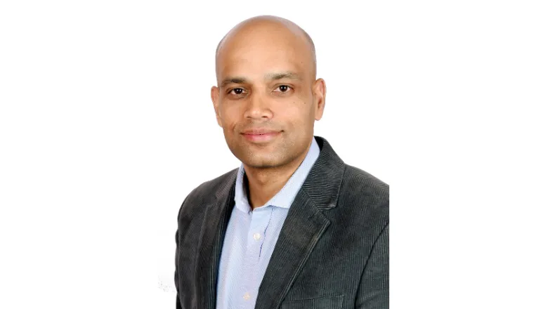 A professional headshot of Professor Vibhu Paudyal against a white background