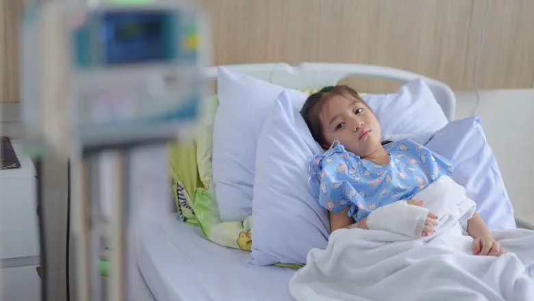 Sick child in a hospital bed