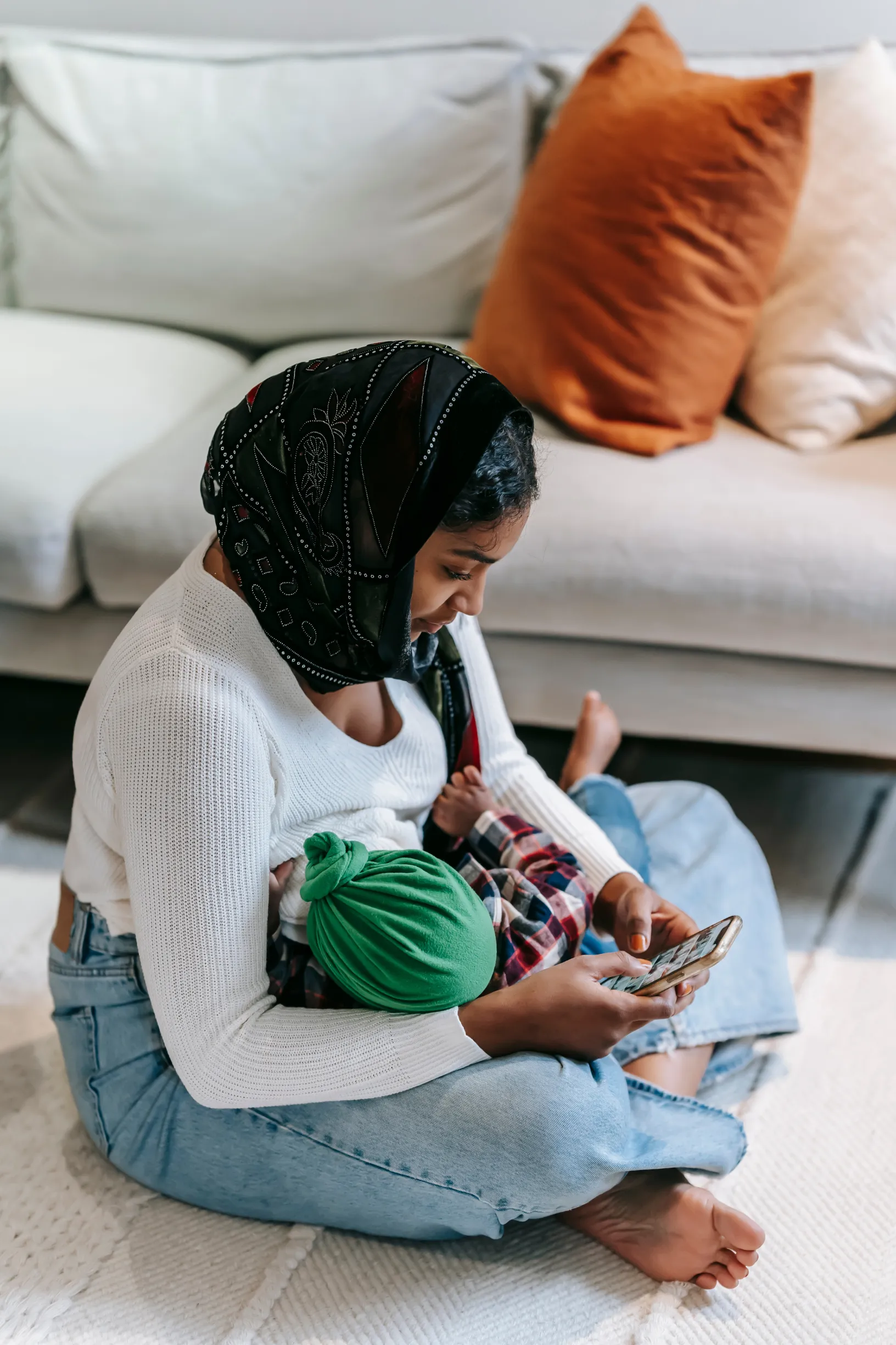 A woman breastfeeding while using a phone