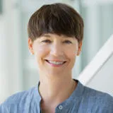 Profile photo of Marie-Agnès Parmentier (a white woman with brown hair in a pixie haircut style, wearing a blue shirt).