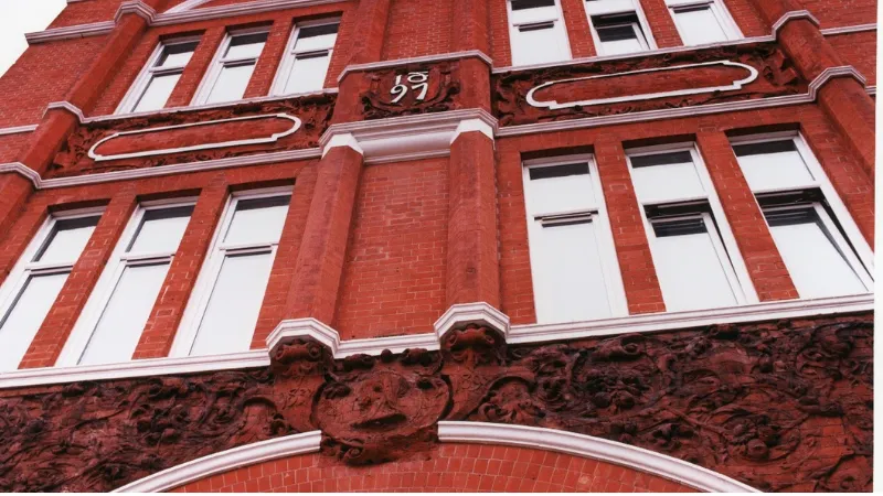 Close up of a red brick building photographed from below