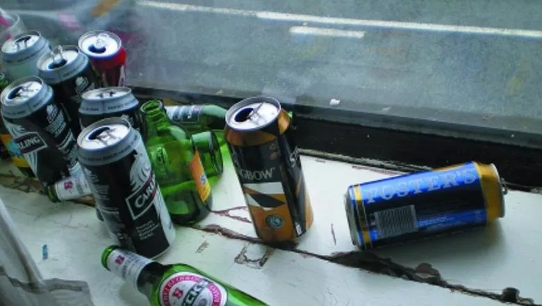 Empty alcohol bottles and cans on a windowsill