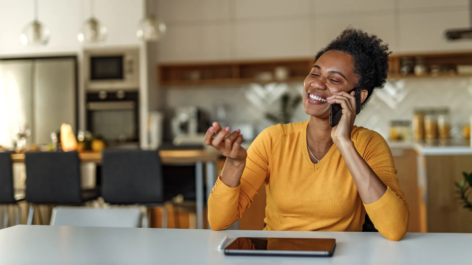 Woman wearing a yellow top talking on the phone