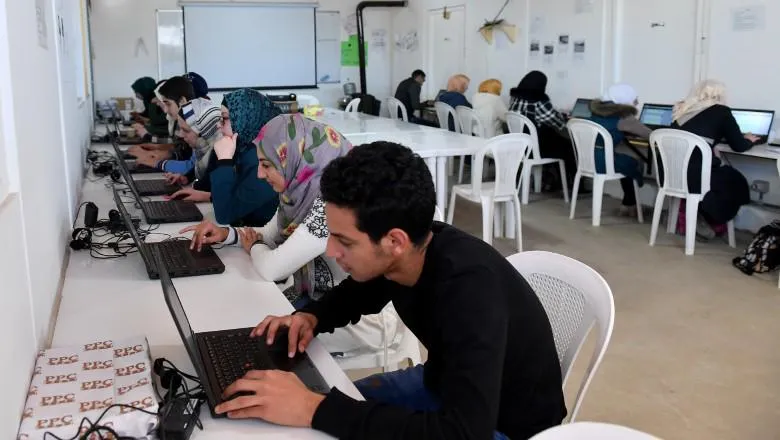 Students studying at laptops