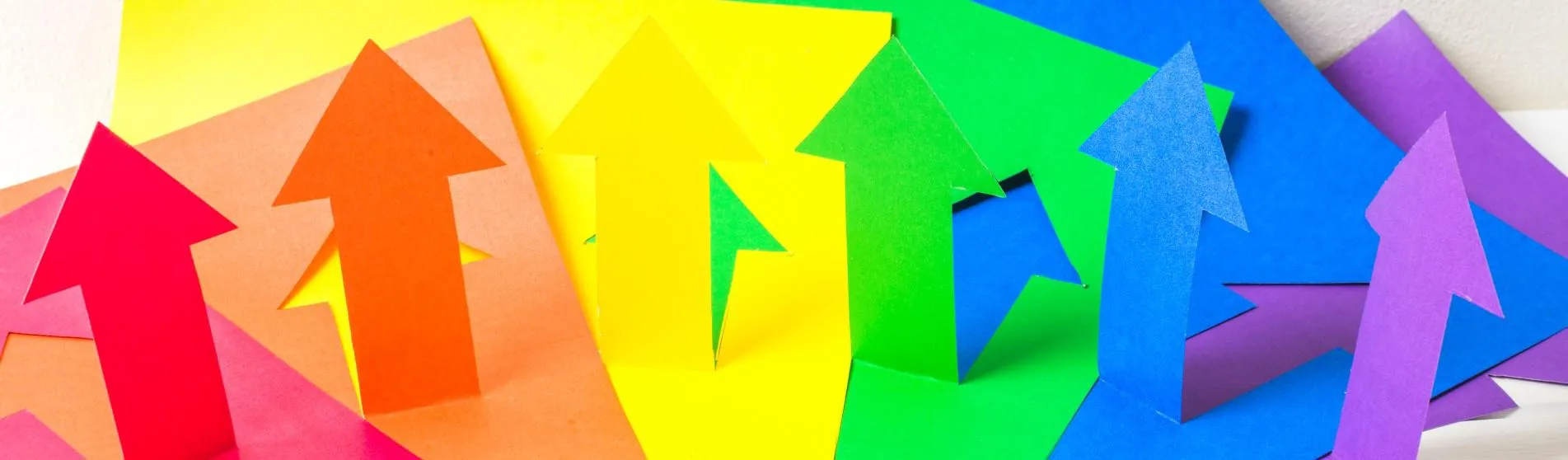 Paper cards in SDG colours pointing upwards