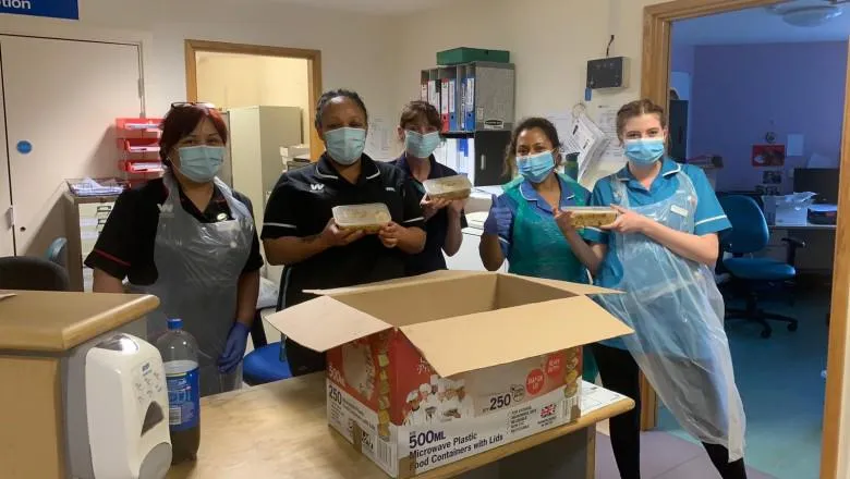 NHS staff with packages from One Million Meals