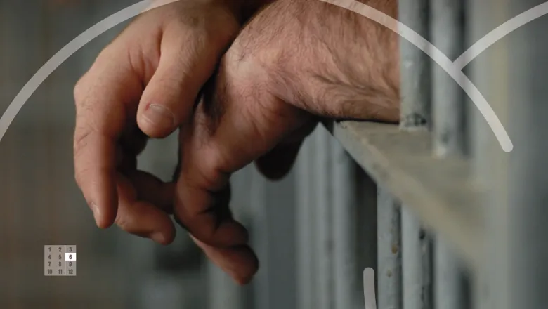 Hands in prison cell