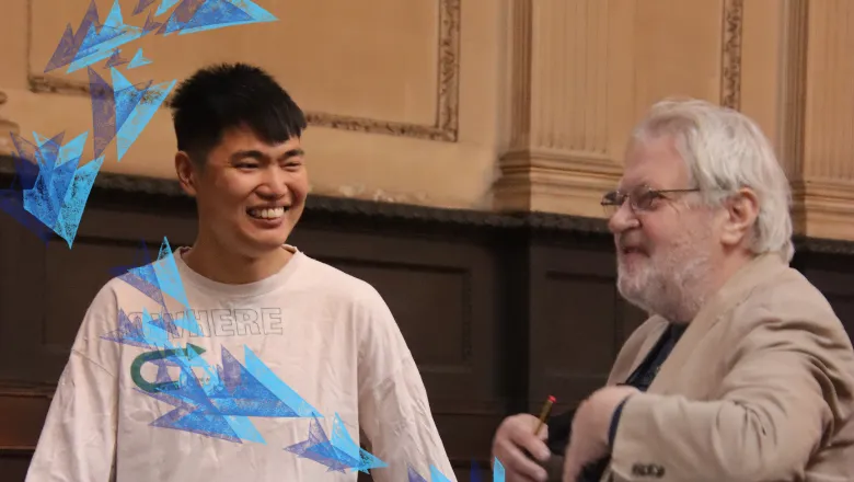 Yihang Qin and an older man stand in the church talking.