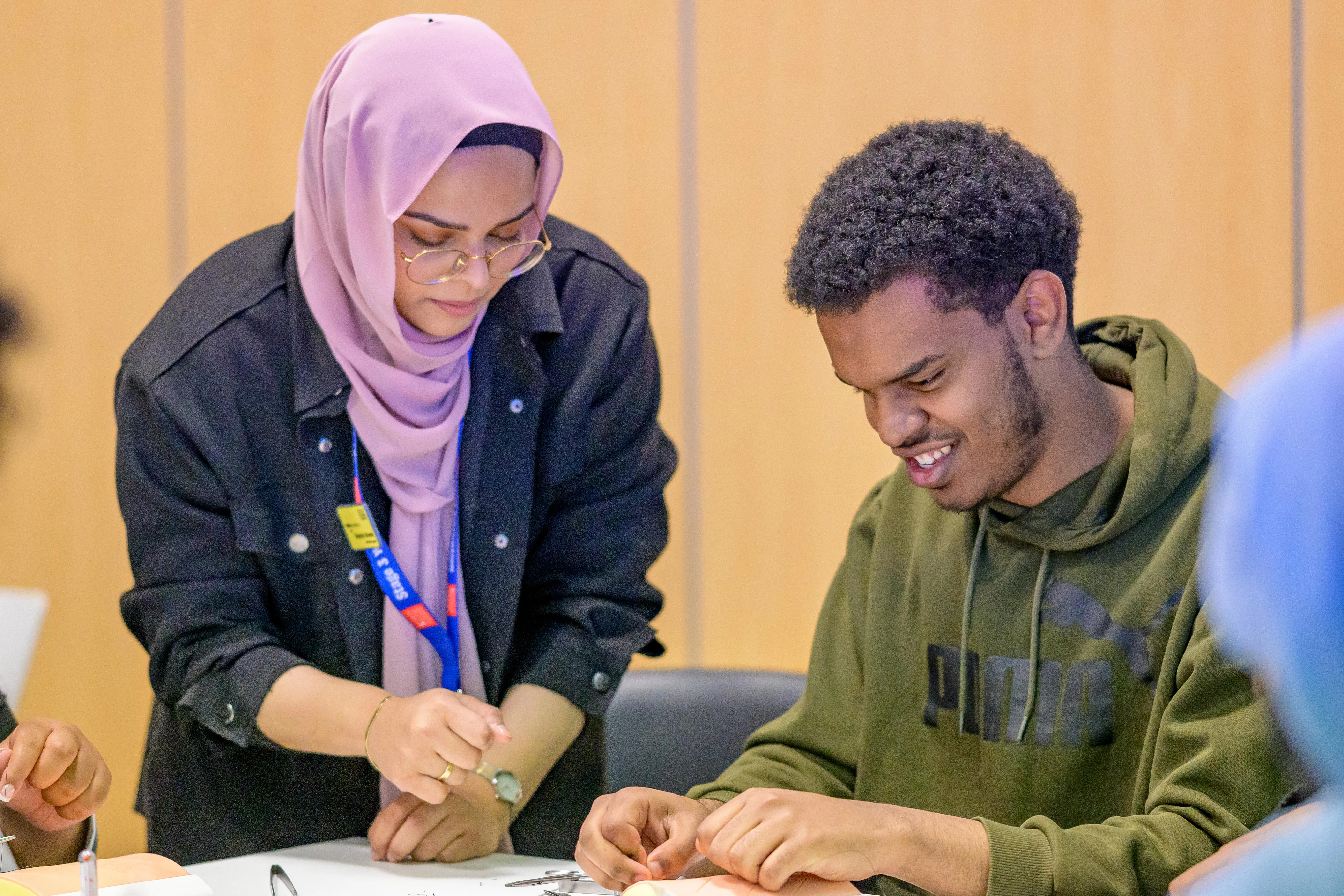 A member of staff helping a student.