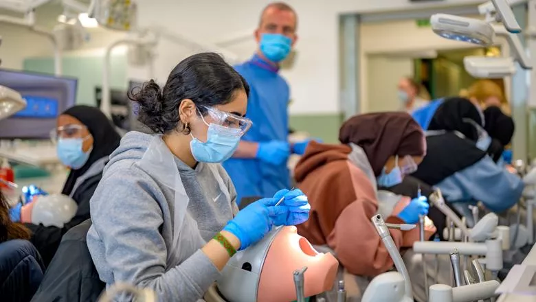 Dentistry student practicing on a dummy