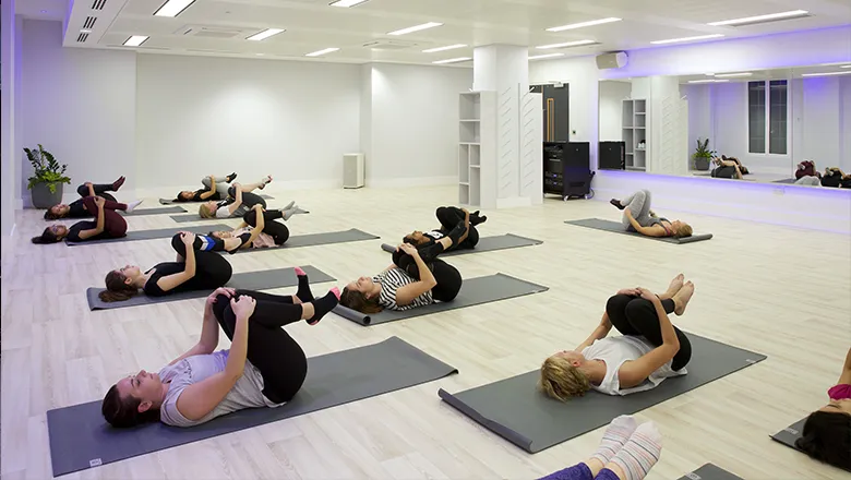 Members participating in a yoga class in Studio 2.