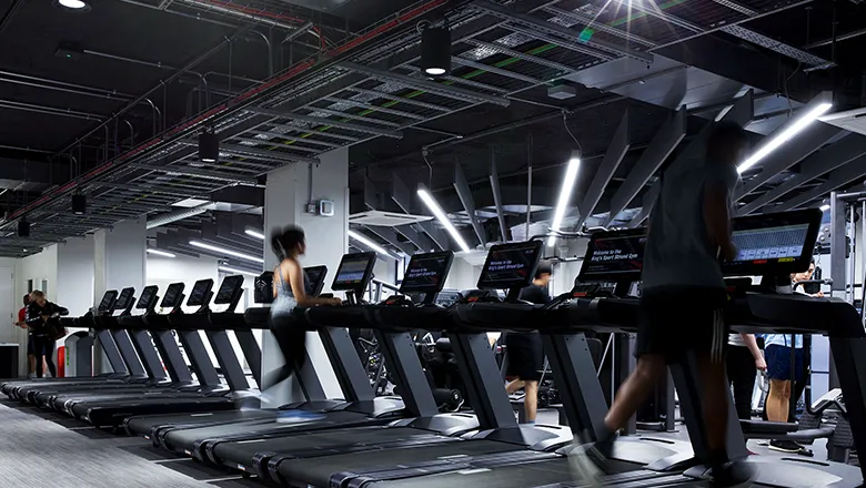 Members using treadmills in strand gym. 