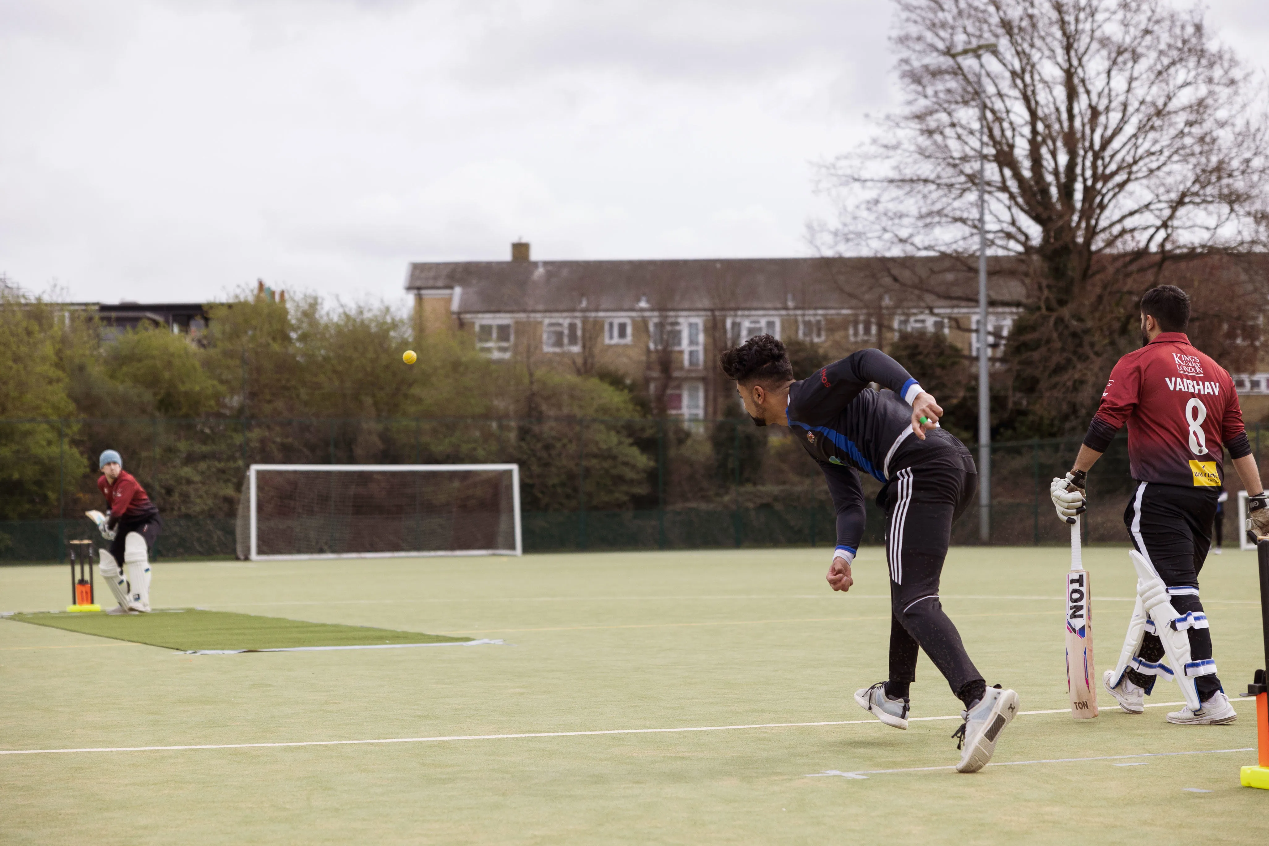 A group of men playing cricket