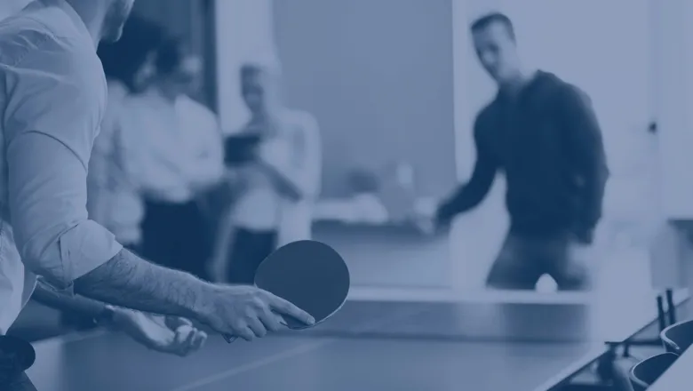 group of individuals playing table tennis
