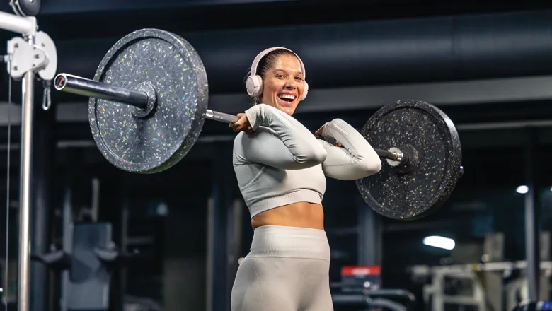 Smiling woman lifting a barbell