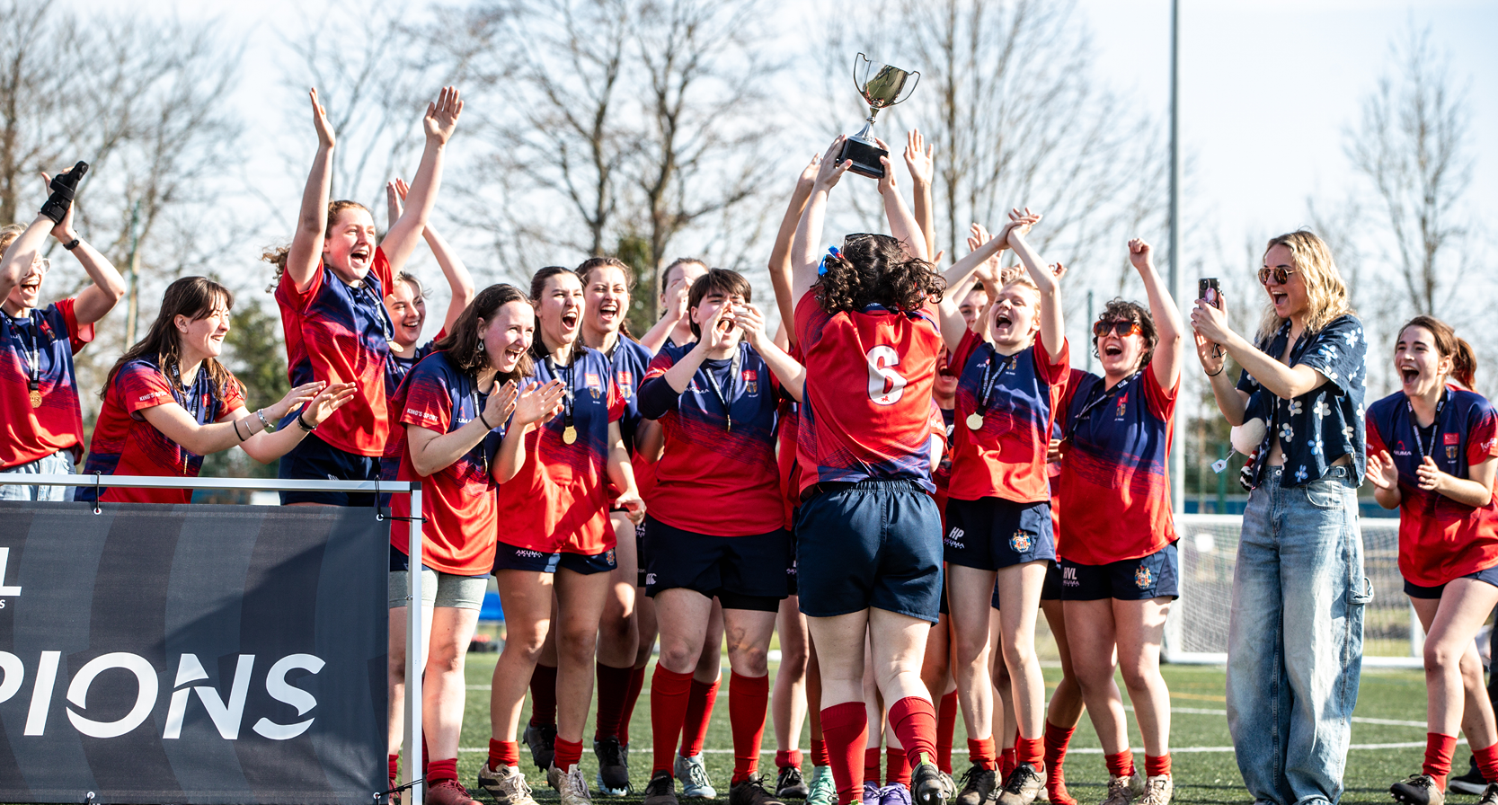 A group of female rugby players celebrating