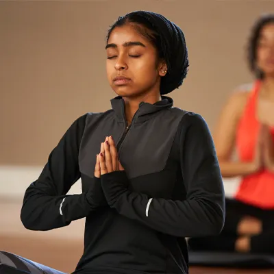 Individual in a yoga class meditating