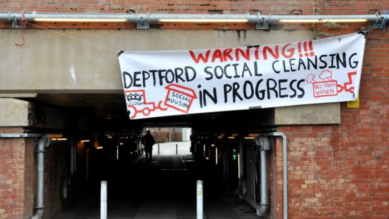 A banner hung by protesters which reads Warning! Deptford social cleansing in progress.