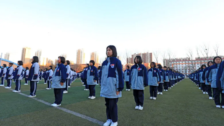 Young females line a school field in China