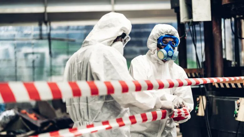 People in hazmat suits in restricted area