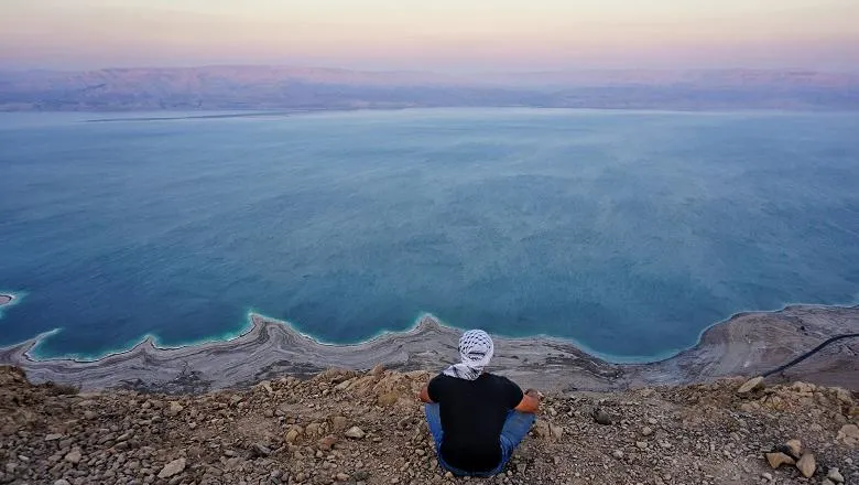 Man sitting at water's edge