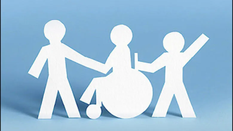 Paper cut-out of three people, one of them a wheelchair user