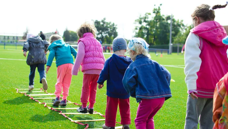 A group of children with backs to the camera