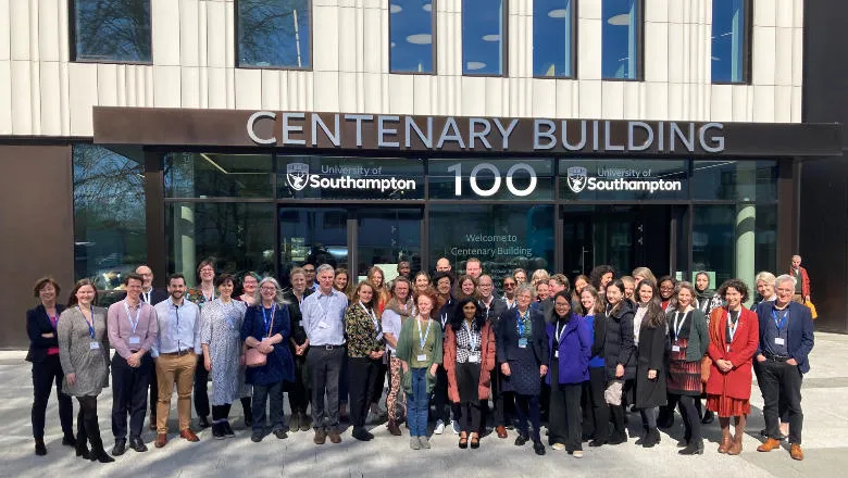 A large group of people standing in front of a building