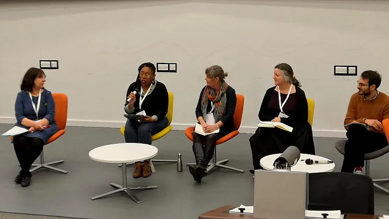 five people seated having a discussion