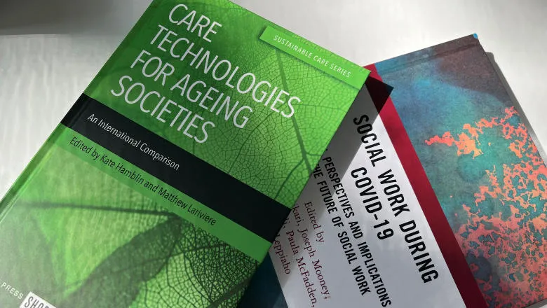 Two hardback books on a table