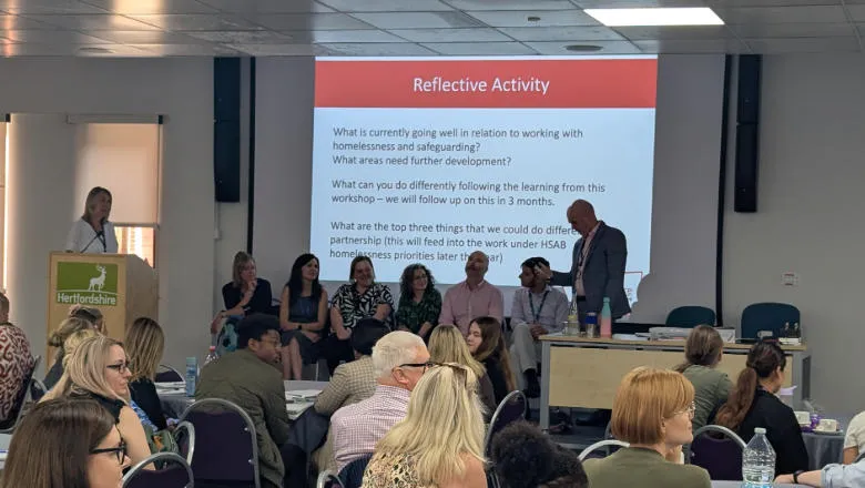 Panel and people in the audience at an event