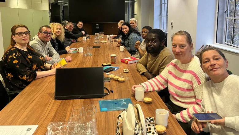 Group of people sitting around a conference table