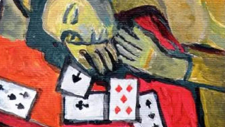 Woman with her head on a table strewn with playing cards