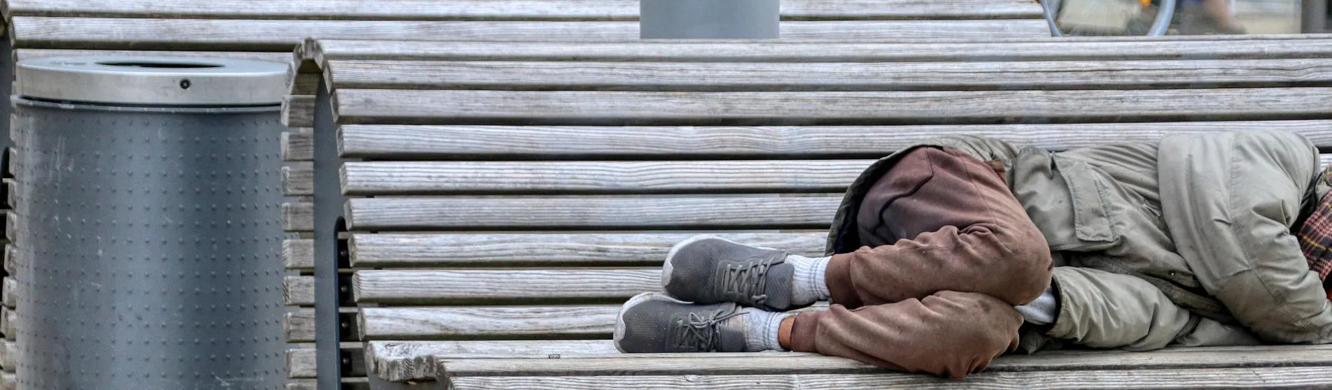 Man sleeping rough on a park bench