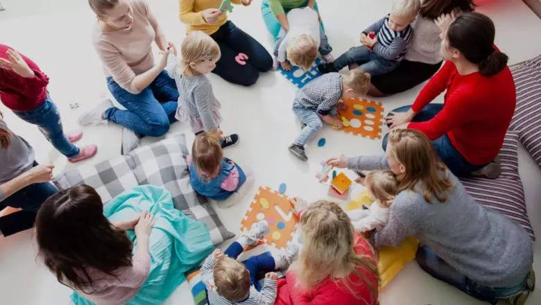 Young children playing with adults
