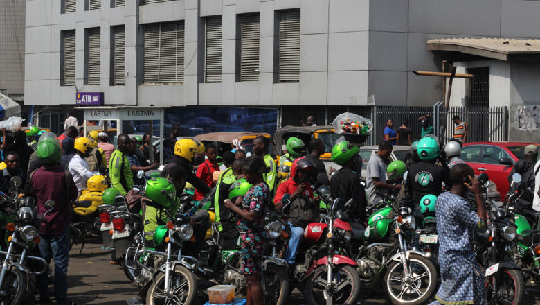 Group of motorcycle Taxi in green helmet gather in wait for business