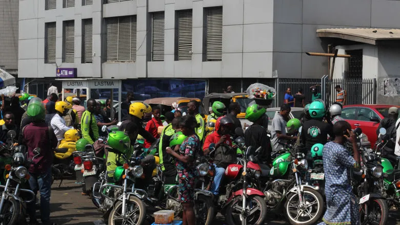 Group of motorcycle Taxi in green helmet gather in wait for business