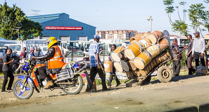 Nairobi, Kenya: Taxi motorcycle and barrels for clean water